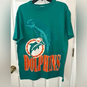 This is a Dolfins vintage 90s Miami Dolphins NFL T-shirt, made by The Game